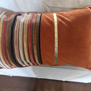 Decorative orange, black and gold pillow cover.